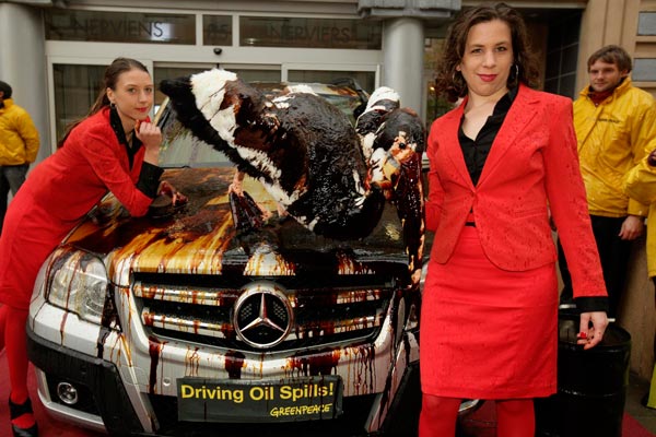 Greenpeace activists splatter luxury cars with oil six months after the Deepwater Horizon explosion, mocking industry car shows, in front of the office of European carmaker association ACEA in Brussels , Belgium. (EPA)