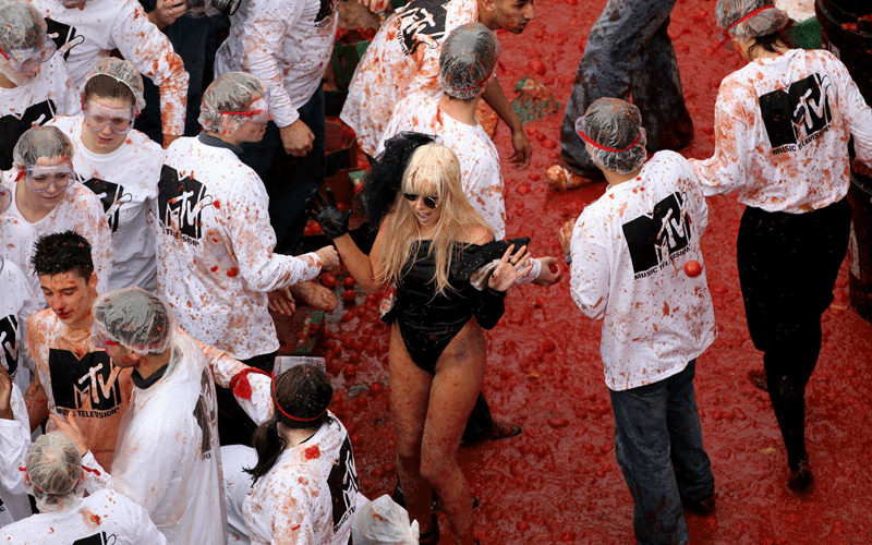 Victoria Cluskey (C), a Lady Gaga lookalike, joins members of the public in a giant food fight with over 25,000 tomatoes in Golden Square on November 2, 2010 in London, England. The tomato fight, aimed to recreate the Spanish 'Tomatina' food throwing contest, is organised by the music television channel MTV to promote the European Music Awards which will be held in Madrid on November 7. (GETTY IMAGES)