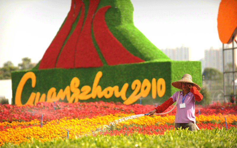 A worker waters a floral feature near the venue for the opening ceremony of the 16th Asian Games in Guangzhou.  The 2010 Asian Games are held in Guangzhou, China, from November 12-27 and will be the biggest ever, with 45 countries and territories taking part in 42 sports. (AFP)