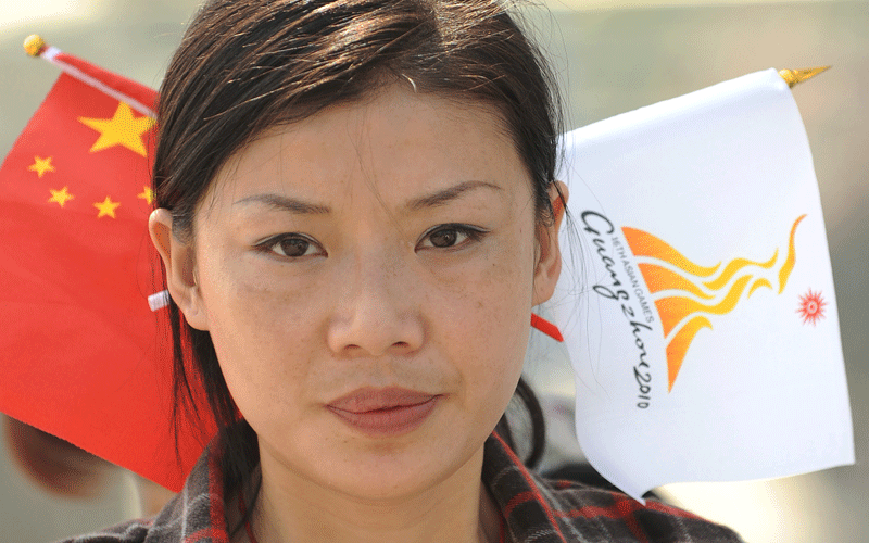 A woman sells flags near the venue of the opening ceremony for the 16th Asian Games in Guangzhou. The 2010 Asian Games are held in Guangzhou, China, from November 12-27 and will be the biggest ever, with 45 countries and territories taking part in 42 sports. (AFP)