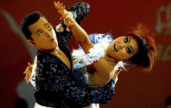 Peng Yen Ming (L) and Chi Hsin Chi of Taiwan compete in the preliminary rounds of the dancesport event at the 16th Asian Games in Guangzhou. (AFP)