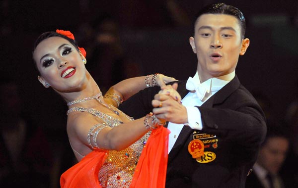 Yang Chao (L) and Tang Yiling of China compete in the dancesport standard quickstep event at the 16th Asian Games in Guangzhou. (AFP)