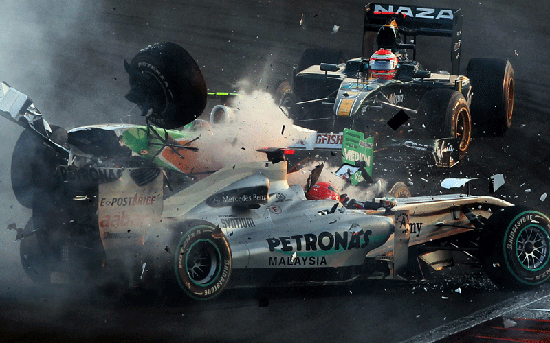 Mercedes GP's German driver Michael Schumacher crashes with Force India's Italian driver Vitantonio Liuzzi  at the Yas Marina circuit on November 14, 2010 in Abu Dhabi, during the Abu Dhabi Formula One Grand Prix. (AFP)