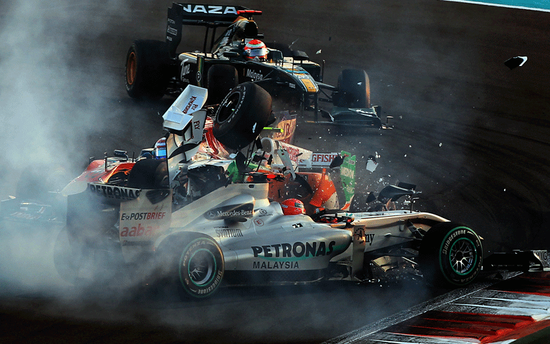 Mercedes GP's German driver Michael Schumacher crashes with Force India's Italian driver Vitantonio Liuzzi  at the Yas Marina circuit in Abu Dhabi, during the Abu Dhabi Formula One Grand Prix. (AFP)