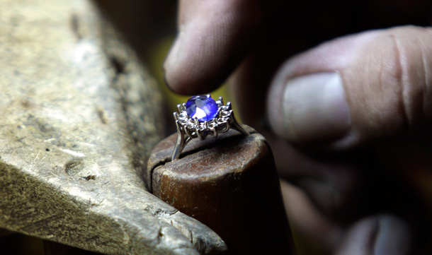 Frank Soto works on a replica of the engagement ring Prince William gave to his fiancee Kate Middleton at Natural Sapphire Co. in New York. Minutes after the world first saw the ring _ an oval blue sapphire surrounded by diamonds that once belonged to William's late mother, Diana, Princess of Wales the phones started ringing off the hook at the Manhattan jewelry maker. (AP)