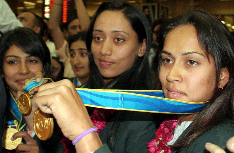 Members of the Pakistan women’s cricket team show their gold medals upon arrival at Jinnah International Airport in Karachi on Sunday. (EPA)