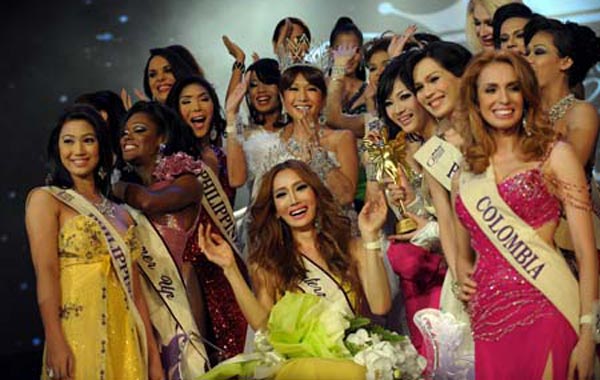 Contestants surround South Korea's Mini (C) after she was crowned Miss International Queen 2010. (AFP)