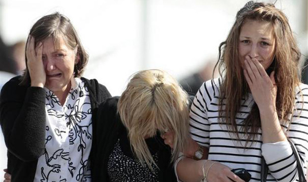 Family members of miners trapped underground in the Pike River coal mine react after learning of a second explosion in the mine at a briefing by mine authorities and police in Greymouth on New Zealand's west coast. (REUTERS)