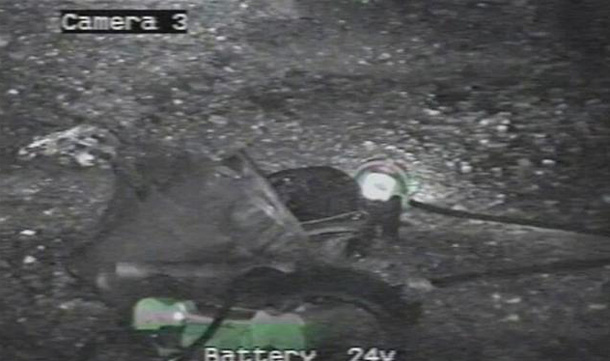 A frame grab from an army robot camera shows mining equipment left on the ground of the Pike River Coal Mine. (REUTERS)