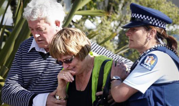 A policewoman supports family members of miners trapped underground in the Pike River coal mine as they react after learning of a second explosion in the mine at a briefing by mine authorities and police in Greymouth on New Zealand's west coast. (REUTERS)