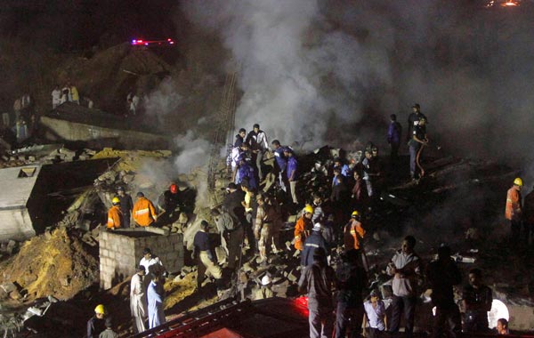 A plane carrying eight people crashed early on Sunday in a residential area of Karachi, Pakistan's biggest city, setting buildings on fire. (REUTERS)