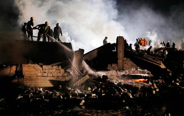 Firefighters douse flames amidst weckage at the site of a plane crash in Karachi. (REUTERS)