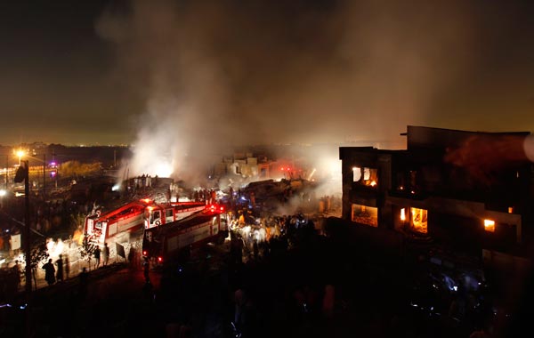 A plane carrying eight people crashed early on Sunday in a residential area of Karachi, Pakistan's biggest city, setting buildings on fire.  (REUTERS)