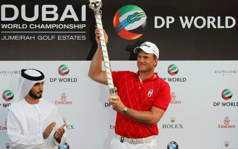 Robert Karlsson of Sweden (right) holds the trophy after receiving it from Sheikh Majed bin Rashed al-Maktoum, son of Dubai ruler Sheikh Mohammed bin Rashed al-Maktoum, after winning the Dubai World Championship at the Earth Course of the Jumeirah Golf Estates in the Gulf emirate. (AFP)