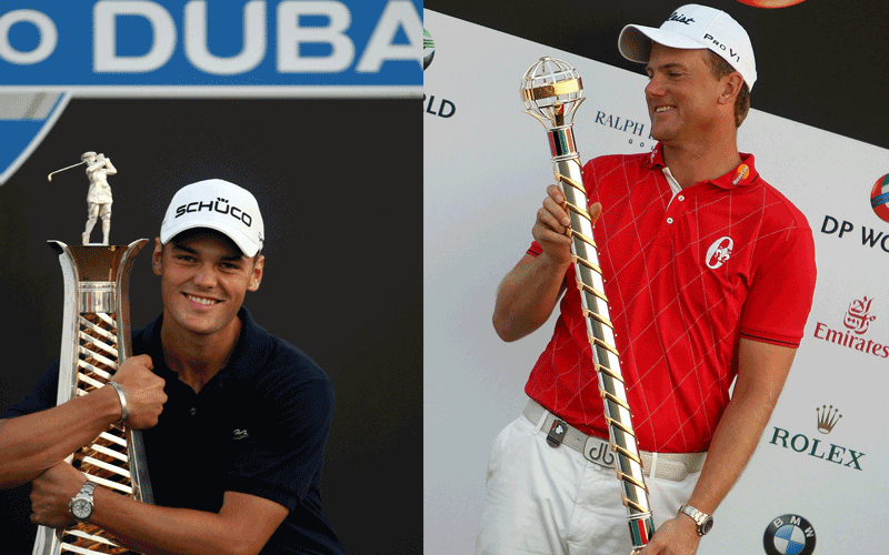 Robert Karlsson of Sweden looks at the trophy after winning Dubai World Championship and Martin Kaymer hugs the trophy of best European Golf player of the year at the Earth Course of the Jumeirah Golf Estates in the Gulf emirate.  (AFP)