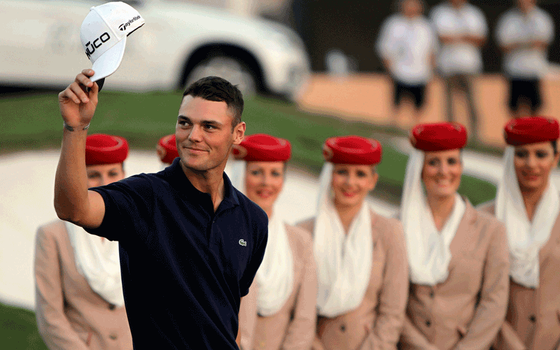 Martin Kaymer salutes the crowds as he arrives to receive the trophy for best European Golf player of the year on the last day of the Dubai World Championship at the Earth Course of the Jumeirah Golf Estates in the Gulf emirate. (AFP)