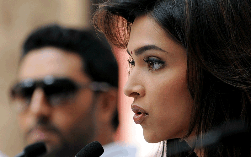 Indian Bollywood actress Deepika Padukone (right) addresses the media as actor Abhishek Bachhan (left) looks during a promotional event for the upcoming Hindi film 'Khelein Hum Jee Jaan Se' in New Delhi.  (AFP)