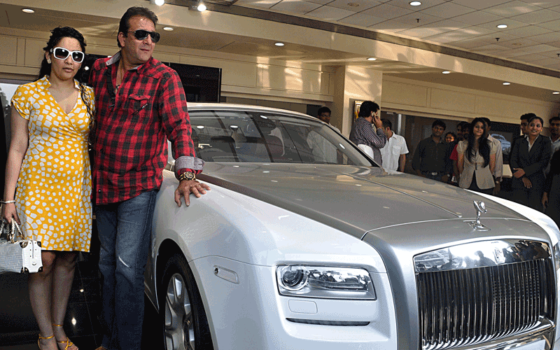 Indian Bollywood actor Sanjay Dutt (right) buys a Rolls Royce 'Ghost' model car to his wife Manyata Dutt (left) in Mumbai after she gave birth to twins. (AFP)