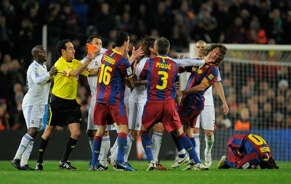 Sergio Ramos of Reral Madrid pushes Carles Puyol's face  (2ndR) during the La Liga match between Barcelona and Real Madrid at the Camp Nou Stadium in Barcelona, Spain.  Barcelona won the match 5-0. (GETTY)