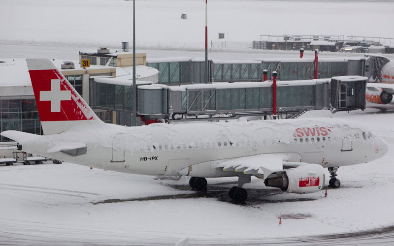 A Swiss International aircraft is covered by snow while the airport is temporarily closed because of heavy snowfall, in Geneva, Switzerland, on Wednesday, Dec 1, 2010. (AP)