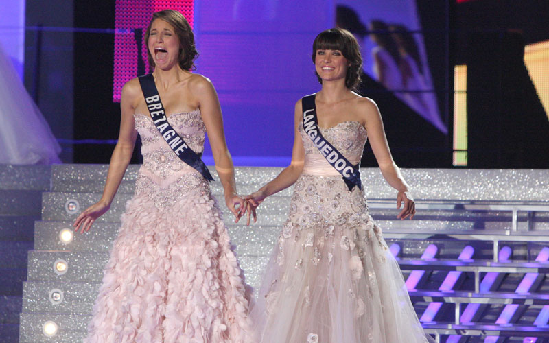 Miss Bretagne, Laury Thilleman (L) reacts next to her first runner-up Miss Languedoc Jenna Sylvestre (R), after being crowned Miss France 2011 during the 64th edition of the beauty contest on December 4, 2009 in Caen, northwestern France. (AFP)