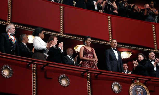 President Barack Obama and first lady Michelle Obama are are applauded by recipients of the 2010 Kennedy Center Honors, from left, Merle Haggard, Oprah Winfrey, Paul McCartney and former Secretary of State Colin Powell, right, and his wife Alma Powell, second right, during the 2010 Kennedy Center Honors at the Kennedy Center in Washington. (AP)