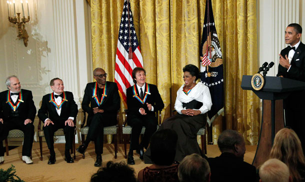 8President Barack Obama, right, speaks during a reception for the recipients of the  2010 Kennedy Center Honors, from left,  Merle Haggard, Jerry Herman, Bill T. Jones, Paul McCartney and Oprah Winfrey in the East Room of the White House in Washington.  (AP)