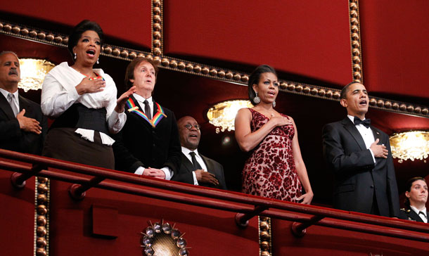 President Barack Obama, right, and first lady Michelle Obama, second from right, with recipients of the 2010 Kennedy Center Honors, from left, producer, television host and actress Oprah Winfrey, songwriter and musician Paul McCartney, sing the National Anthem during the 2010 Kennedy Center Honors Gala at the Kennedy Center in Washington. At far left in the background is Stedman Graham. (AP)