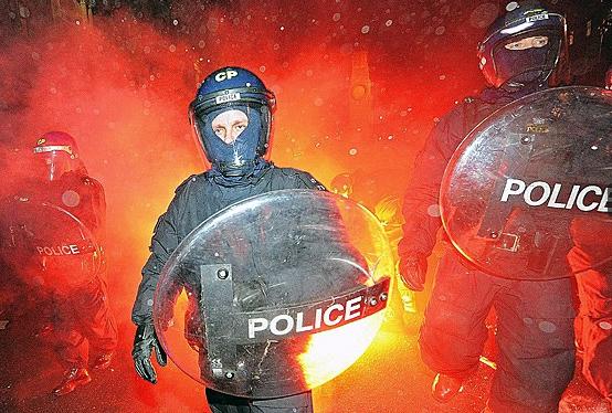 Riot police are attacked by flares as they engage with the student protesters. Thirty-four people were arrested and at least 43 protesters and 12 police officers were injured during the fierce clashes outside parliament  (AFP)