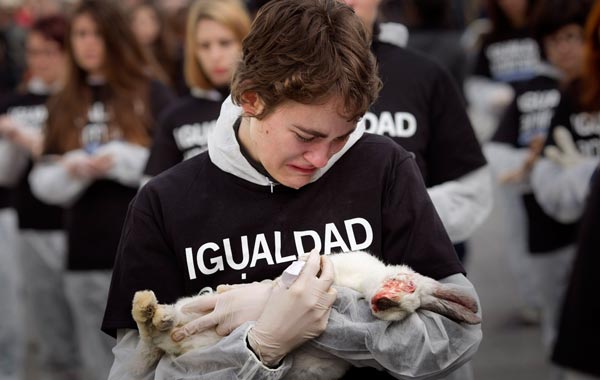 An animal right activist cries while she holds a dead rabbit during a protest on the International day of Animals Rights in Madrid. (AP)