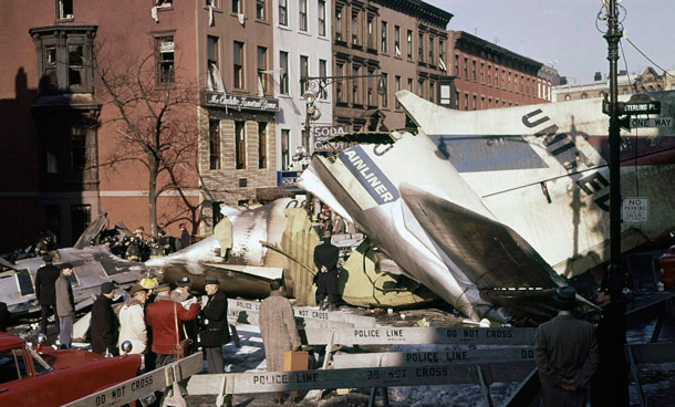 Rescue workers search for survivors in the remains of the United Air Lines jet that crashed at Seventh Avenue and Sterling Place in the Brooklyn neighborhood of Park Slope after the airliner collided with a TWA propeller plane one mile above New York City. It was the deadliest air disaster up to that time, killing all 128 people on both aircraft and six on the ground. (AP)