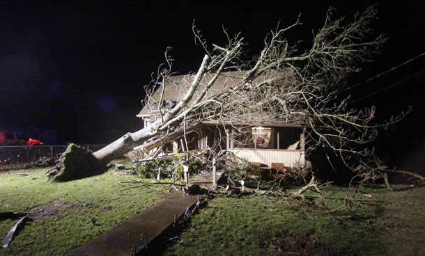 Lights shine on a home damaged by a tornado, in Aumsville, Ore. The tornado struck the small town on Tuesday, tearing roofs off buildings, hurling objects into vehicles and homes and uprooting trees. No injuries were reported. There were early reports that some people had been trapped in cars. (AP)