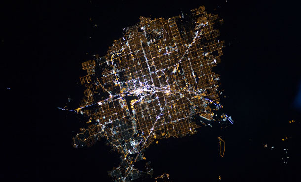 This image provided by NASA shows the lights of Las Vegas taken from the International Space Station. The surrounding dark desert presents a stark contrast to the brightly lit, regular street grid of the developed metropolitan area. The Vegas Strip (center) is reputed to be the brightest spot on Earth due to the concentration of lights associated with its hotels and casinos. Acquisition of focused night time images such as this one requires space station crew members to track the target with the handheld camera while the ISS is moving at a speed of more than seven kilometers per second (15,659 miles per hour) relative to Earth's surface. (AP)