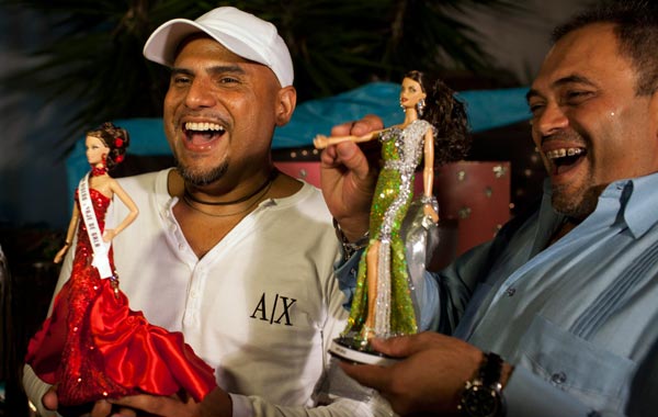 Contestants Jose Luis Revette (L) and Ricardo Mendible react after hearing the results of the Miss Barbie Venezuela 2010 beauty pageant in Caracas. (REUTERS)