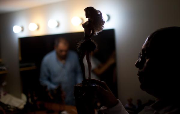 Contestant Johnny Fuentes prepares his Barbie doll "Shantal Martinez Gruber", entering the contest as "Miss Guarico" during the Miss Barbie Venezuela 2010 beauty pageant in Caracas. (REUTERS)