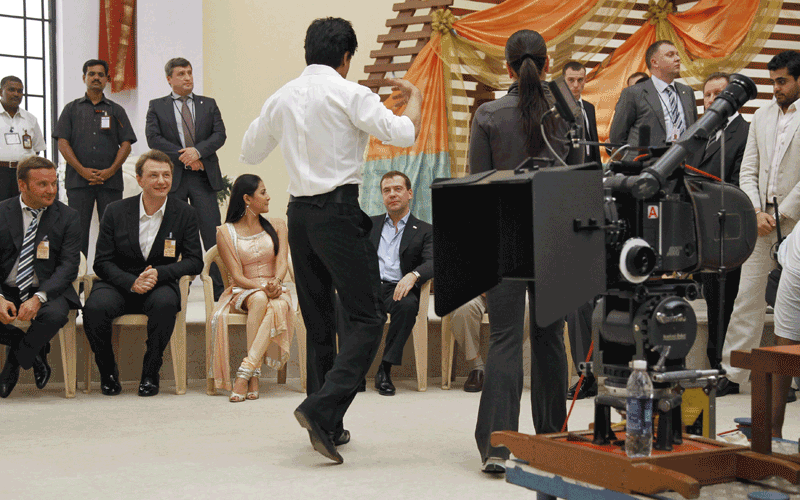 Russia's President Dmitry Medvedev (C in the foreground) visits a Bollywood studio in Mumbai. (REUTERS)