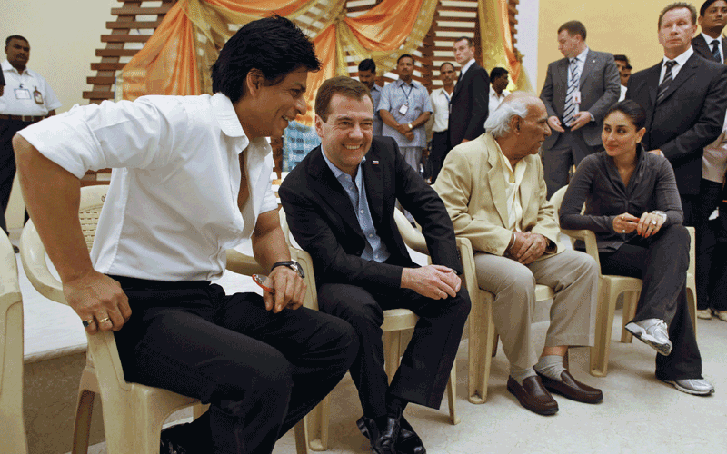 Russia's President Dmitry Medvedev (2nd L) talks to an Indian actor Shah Rukh Khan (L) as he visits a Bollywood studio in Mumbai.  (REUTERS)