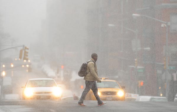 A man crosses Lexington Avenue on the east side of Manhattan as snow falls in New York. A blizzard warning is in effect for the northeast US as 8 to 16 inches (20 to 40 cm) of snow is forcast for the New York area. (AFP)