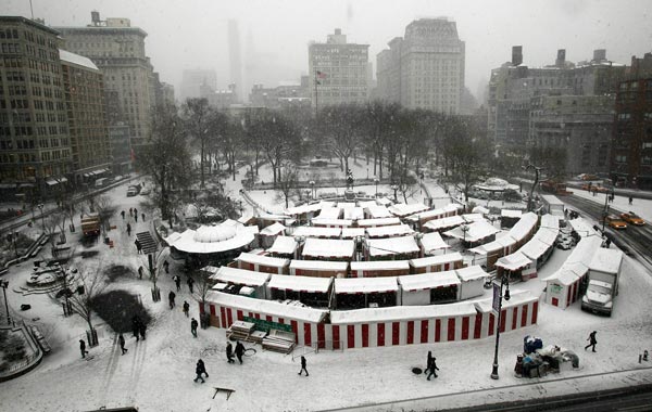 People walk through the afternoon snow in Manhattan's Union Square in New York City. (AFP)