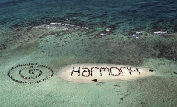 Hundreds of Belizians and international supporters gather on an island to form a message on the Barrier Reef off the coast of Belize City. (REUTERS)