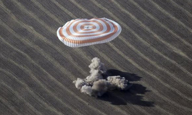 The Russian Soyuz space capsule lands with Expedition 20 Commander Gennady Padalka of Russia, Flight Engineer Michael Barratt of the U.S. and Canadian circus billionaire Guy Laliberte in the vast steppe near the town of Arkalyk in northern Kazakhstan. (REUTERS)