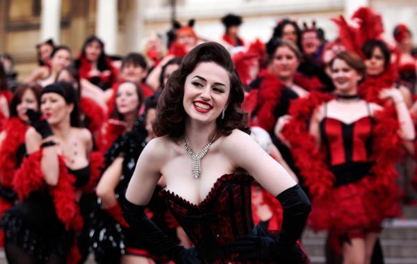 Kimberley Dunne and other burlesque enthusiasts in outfits pose for the photographers in front of the National Gallery in central London's Trafalgar Square, during a world record attempt to break what they called the World's Largest Burlesque Dance. (AP)