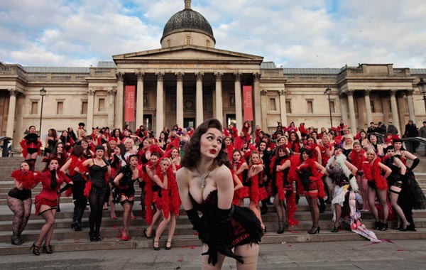 Kimberley Dunne and other burlesque enthusiasts in outfits pose for the photographers in front of the National Gallery in central London's Trafalgar Square, during a world record attempt to break what they called the World's Largest Burlesque Dance. (AP)