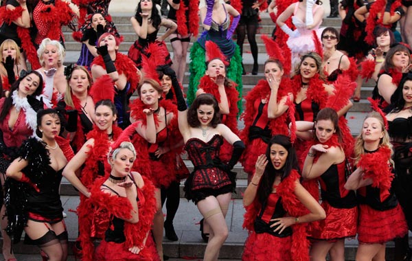 Kimberley Dunne, center, and other burlesque enthusiasts in outfits pose for the photographers in front of the National Gallery in central London's Trafalgar Square, during a world record attempt to break what they called the World's Largest Burlesque Dance. (AP)