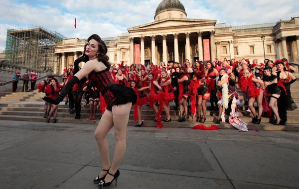 Kimberley Dunne and other burlesque enthusiasts in outfits pose for the photographers in front of the National Gallery in central London's Trafalgar Square, during a world record attempt to break what they called the World's Largest Burlesque Dance. (AP)