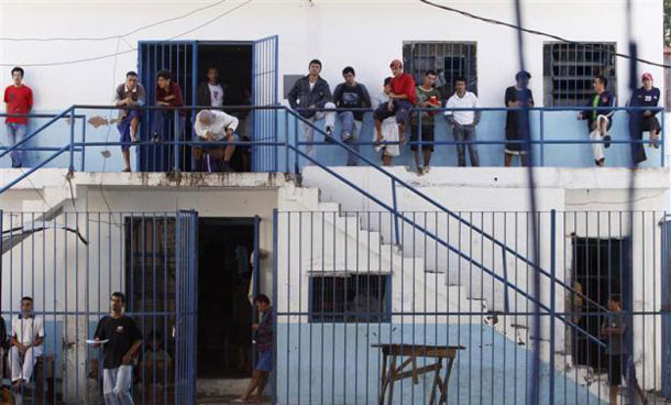 Inmates of the Tacumbu maximum security prison mill around inside their section as judges and district attorneys from the Justice Ministry made their biannual visit to verify the status of the cases of those accused of crimes but whose trials are delayed, in Asuncion. (REUTERS)