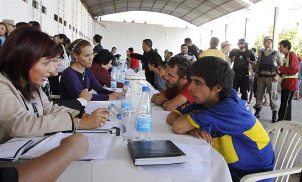 Judges and district attorneys from the Justice Ministry interview inmates (right side of the table) at the Tacumbu maximum security prison during a biannual visit to verify the status of the cases of prisoners accused of crimes but whose trials are delayed, in Asuncion. (REUTERS)