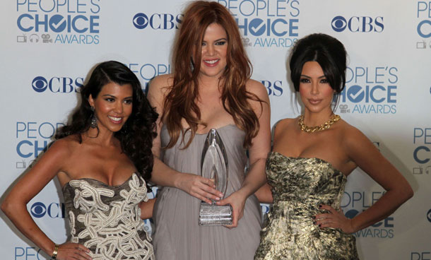 Kourtney Kardashian (L), Khloe Kardashian (C) and Kim Kardashian (R) pose at the People's Choice Awards in Los Angeles, California. (AFP)