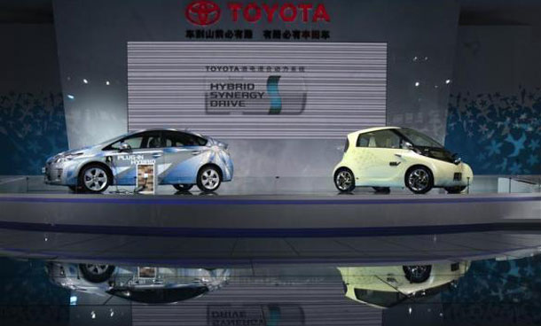 A Toyota Prius plug-in hybrid car (L) and a compact electric FT-EV II concept car at the Guangzhou Autoshow. (REUTERS)