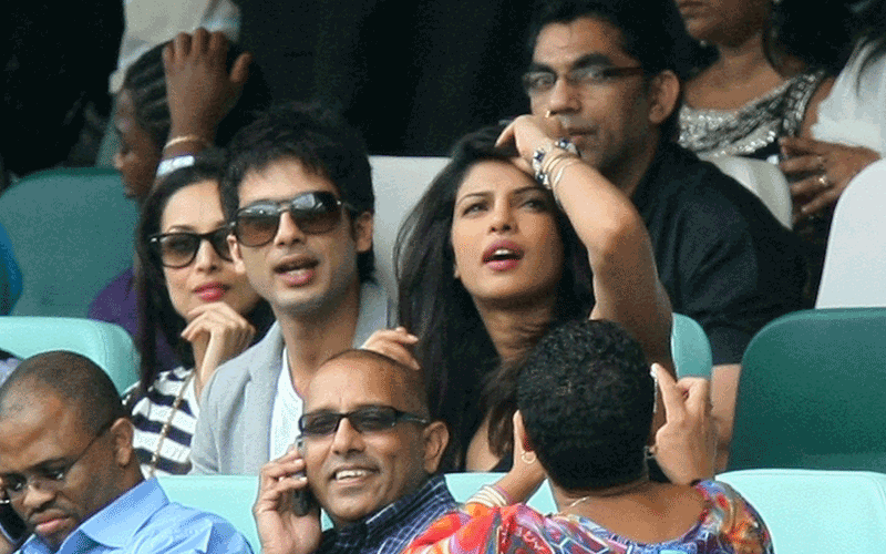 Bollywood actors Shahid Kapoor (centre L) and Priyanka Chopra (centre R) watch the Standard Bank Pro20 international match between South Africa and India at Moses Mabhida Stadium in Durban, South Africa. (Getty Images)